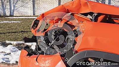 Orange car crash background. Close-up detail of auto wreck. Front side of crashed car from accident. Car accident. Stock Photo