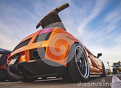 Orange car in the sunset clouds Editorial Stock Photo