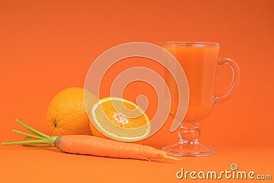 Orange and carrot smoothie in a glass glass on an orange background Stock Photo