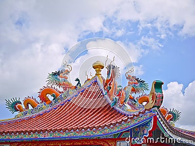Orange china dragon statue on the roof of octagon pavilion and blue sky Stock Photo