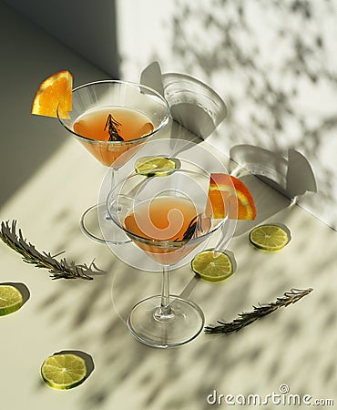 Orange cocktails with orange in glass glasses with a sprig of rosemary. Stock Photo