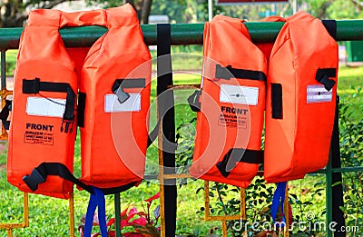 Safety jackets kept in a park for swimming Stock Photo