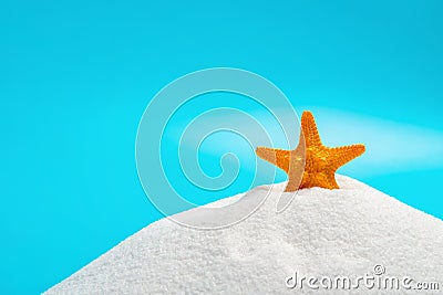 Orange color starfish on white sand on blue concept of summer vacations Stock Photo