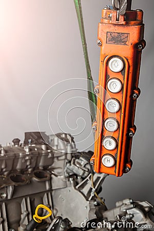 Orange control panel for a crane in an in-booster production or in a car service with buttons for moving in different directions Stock Photo