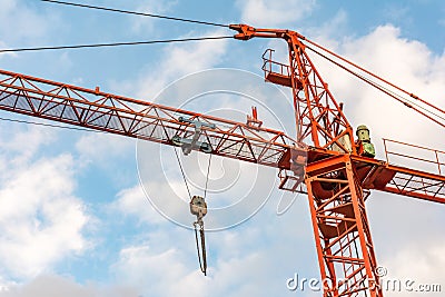 Orange crane in a day of blue skies and with clouds Stock Photo