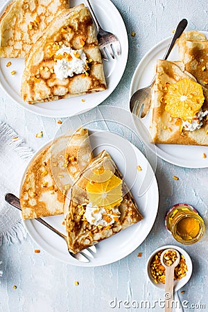 Orange and cream with nuts crepes with honey Stock Photo