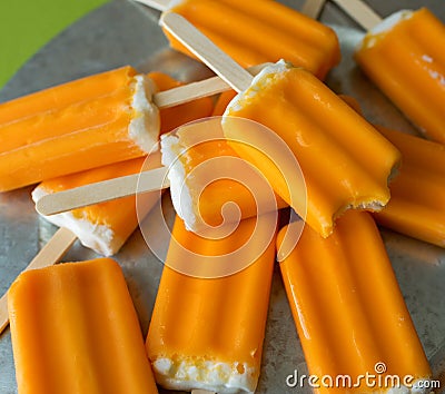 Orange creamsicle popsicles on a galvanized steel platter. Stock Photo