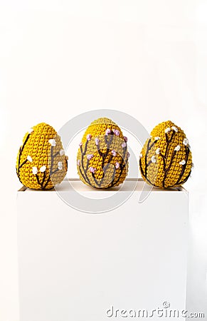 Orange crocheted Easter eggs on a white background with copy space, front view banner Stock Photo