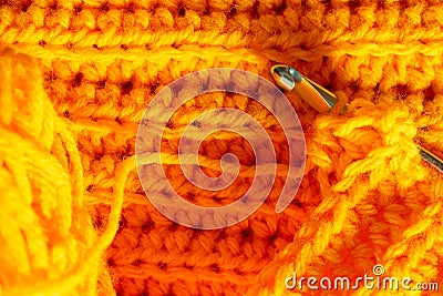 Orange crocheted texture and hook Stock Photo