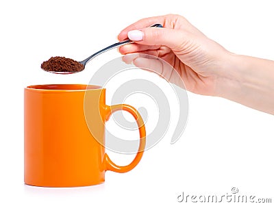 Orange cup mug with spoon coffee in hand Stock Photo