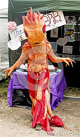 Orange dragon costume at faerie festival Editorial Stock Photo