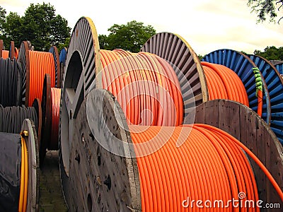 Orange electricity cable on wooden spools Stock Photo