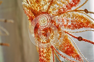 Orange embroidered flower on a delicate sheer curtain fabric Stock Photo