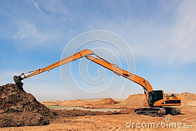 Orange excavator at construction site Stock Photo