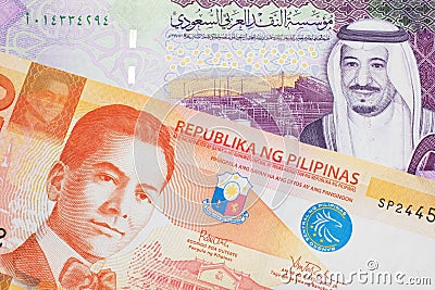 Orange Filipino money close up with money from Saudi Arabia Stock Photo