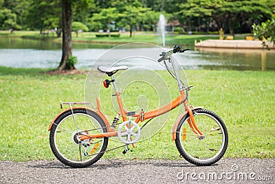 Orange folding bicycles in park Stock Photo
