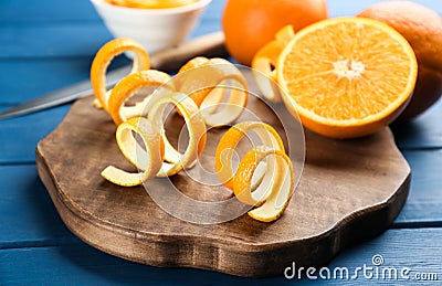 Orange fruit with peels on blue wooden table Stock Photo