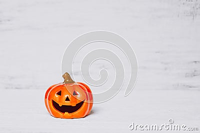 Orange ghost pumpkins on grunge rusty white wooden borad background with copy space for your text. halloween background minimal Stock Photo