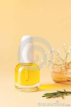 Orange glass bottle with pipette is full of serum or essential oils on beige background Stock Photo