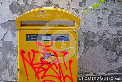 Orange graffitis on a french mailing box Editorial Stock Photo