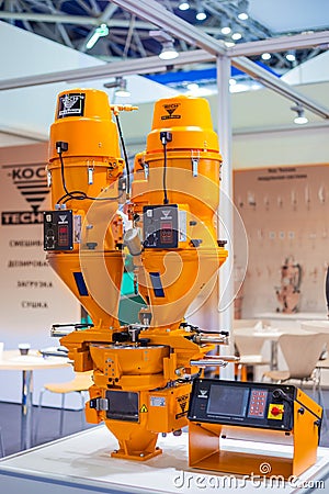 Orange gravimetric dosing mixing system - Koch technik at plastic exhibition Editorial Stock Photo