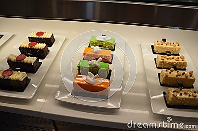 orange and green cakes or desserts in display case Stock Photo