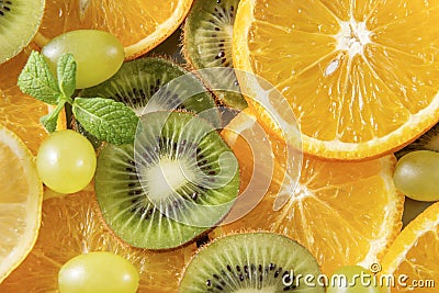 Orange , green grapes, kiwi, mint sprig fresh citrus, top view Stock Photo