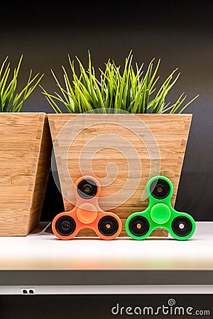 Orange and green hand spinner Stock Photo