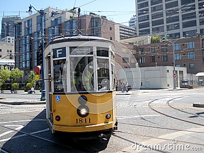 Orange historic streetcar F-Line MUNI Train filled with people Editorial Stock Photo