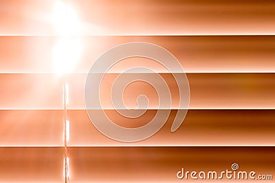 Orange horizontal blinds on the window create a rhythm through t Stock Photo