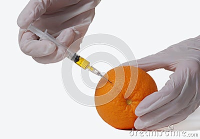 Orange with hypodermic needle Stock Photo