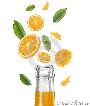 Orange juice bottle and Falling juicy oranges with green leaves isolated on transparent background. Flying defocusing slices of Stock Photo
