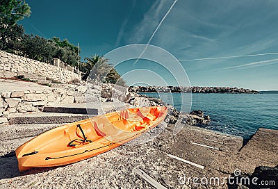 Orange kayak is on the sea pier, Adriatic seaside od Croatia Stock Photo
