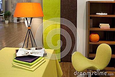 Orange lamp with green chair Stock Photo