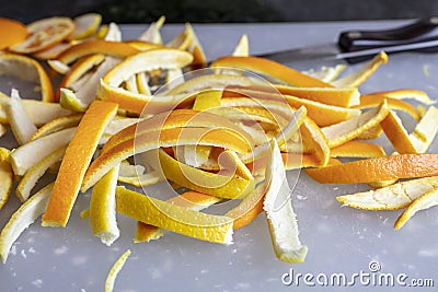 Orange and Lemon Peels being sliced to make Candied Orange and Lemon Peels Stock Photo