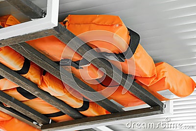 Orange life jackets for extremal situations on tourist boat Stock Photo