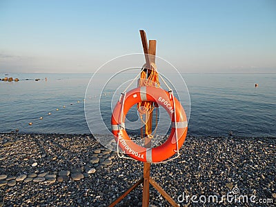 Orange lifebuoy on a pebble beach at the Black Sea Stock Photo