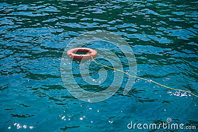 Orange lifebuoys float on the sea Stock Photo