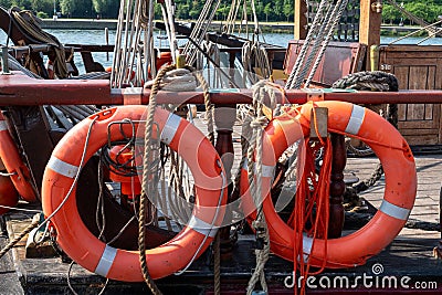 orange lifebuoys on old sailboat Stock Photo