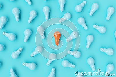 Orange Light bulb Among blue Light bulbs on blue background. Stock Photo