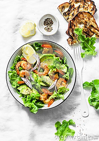 Orange marinated prawns, avocado, garden herbs salad - delicious healthy snack, appetizers, tapas on a light background, top view Stock Photo