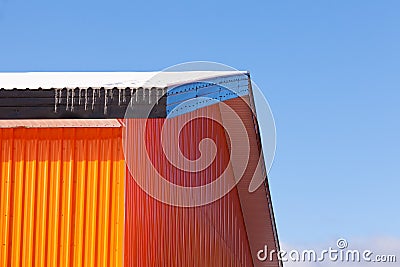 Orange metal sheet siding warehouse construction Stock Photo
