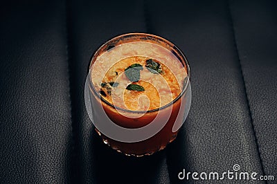 Orange and mint summer smoothie on black background Stock Photo