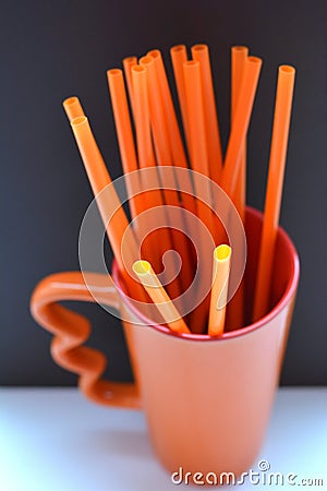 Orange objects cup and tubes Stock Photo