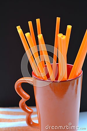 Orange objects cup and tubes Stock Photo
