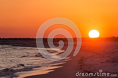 Orange Ocean beach sunset. Tropical Gulf Coast ocean beach sunset scene. Stock Photo
