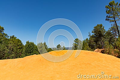 Orange ochre pigment picturesque hills. Languedoc - Roussillon, Stock Photo