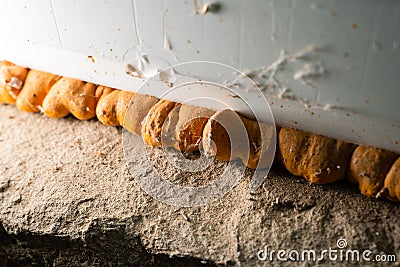Orange old polyurethane foam between wall and plastic window close-up Stock Photo
