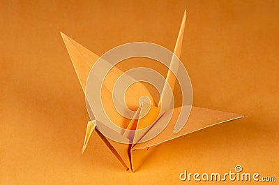 Orange origami crane tsuru on orange background Stock Photo
