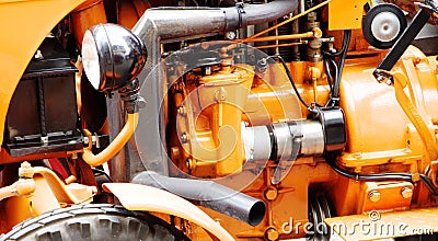 Orange-painted engine compartment of a vintage tractor Stock Photo